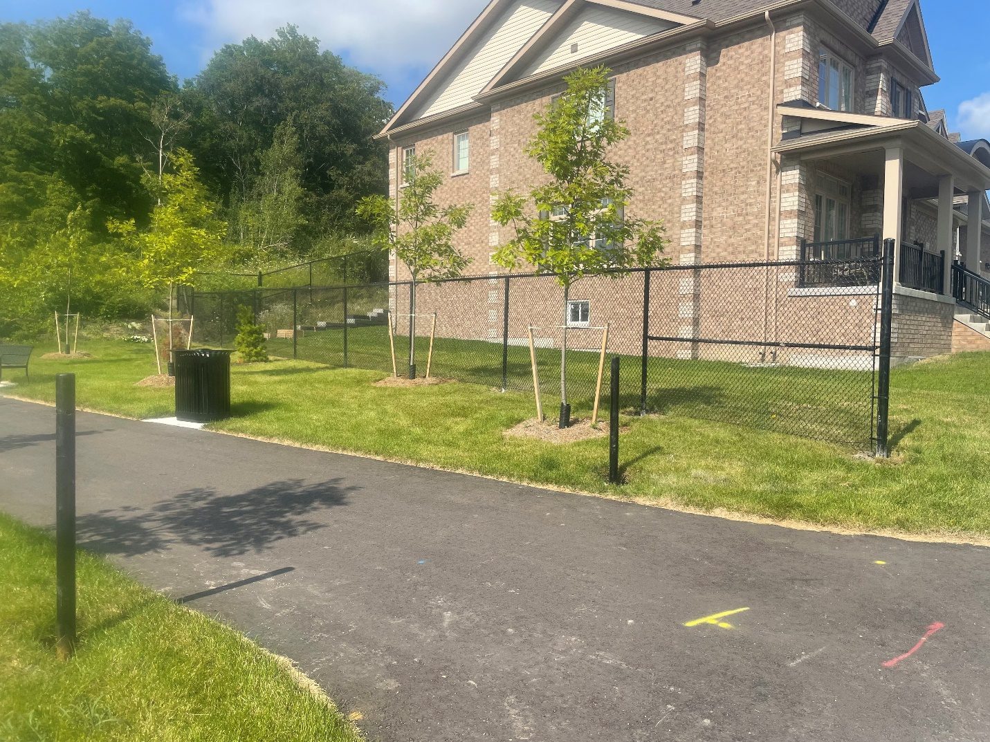 Brick house with chain-link fence and pathway