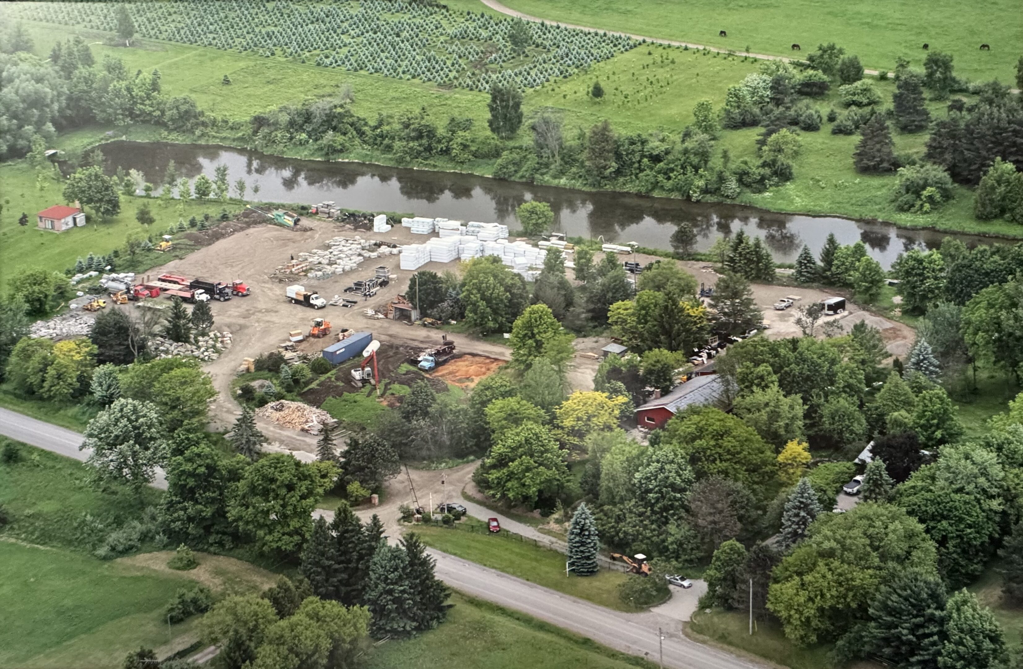Aerial view of rural storage yard by river