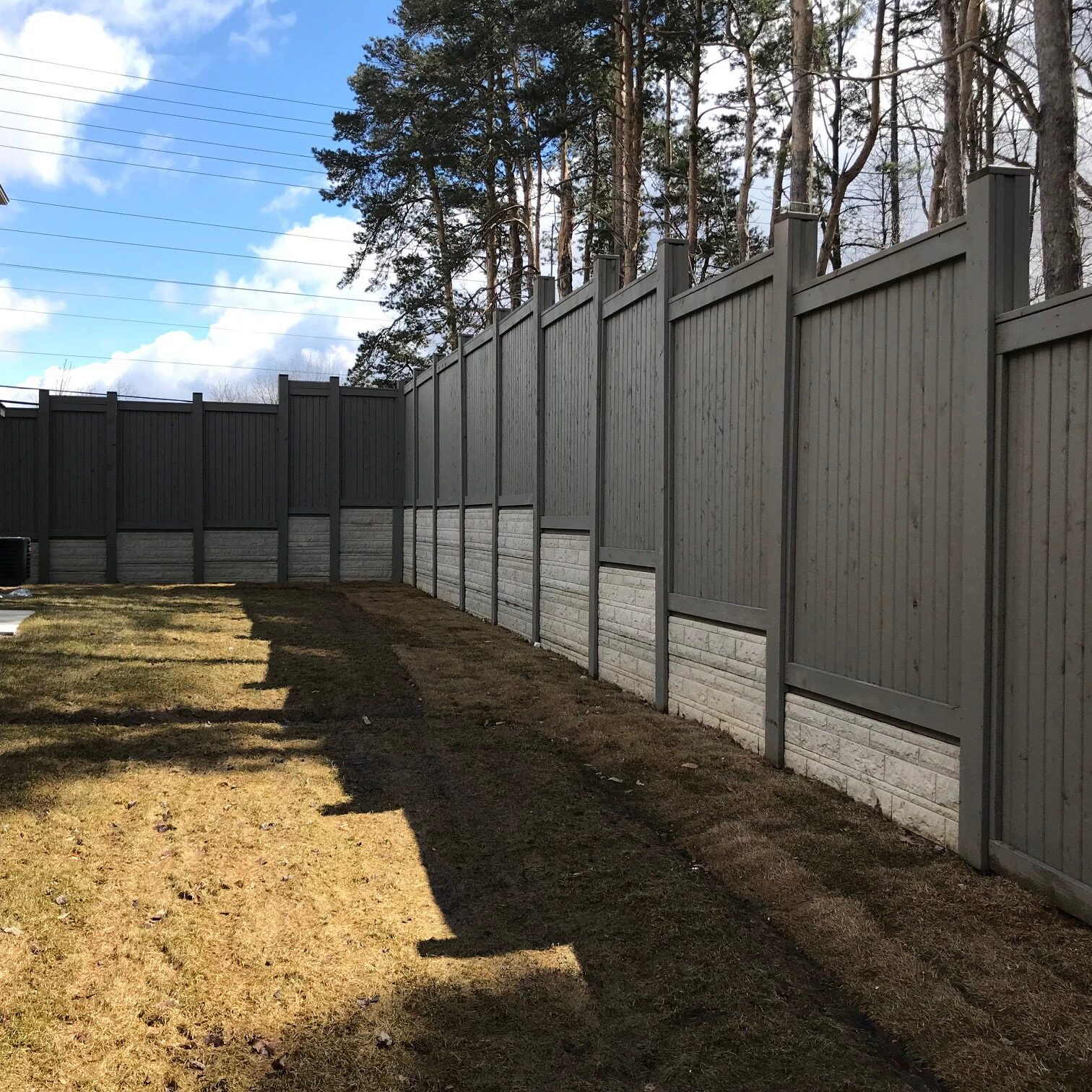 Backyard with tall gray privacy fence